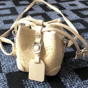 Cream Embossed Crossbody Bag with Playful Motif